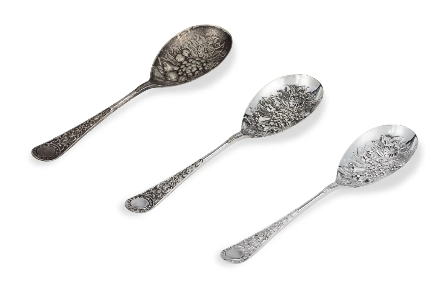 Three ornate berry spoons — one tarnished before re-plating, two brightly restored after