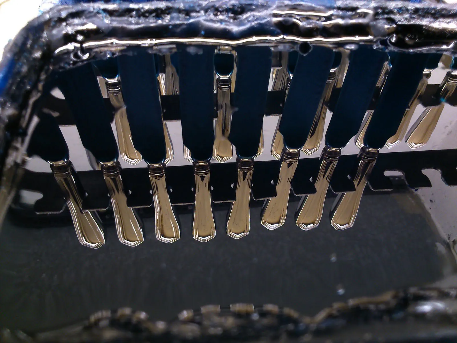 Silver-plated cutlery handles drying after plating